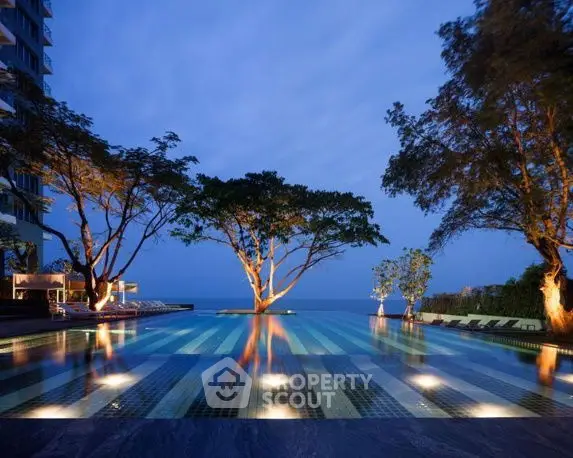 Luxurious infinity pool with stunning ocean view and ambient lighting