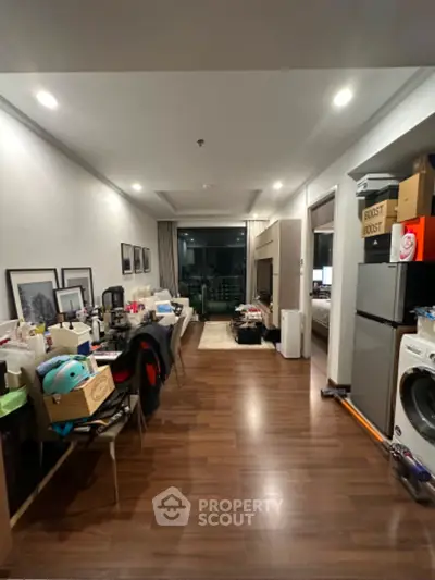 Spacious living area with hardwood flooring and ample lighting, ready for personal touches and decluttering to transform into a cozy, inviting space.