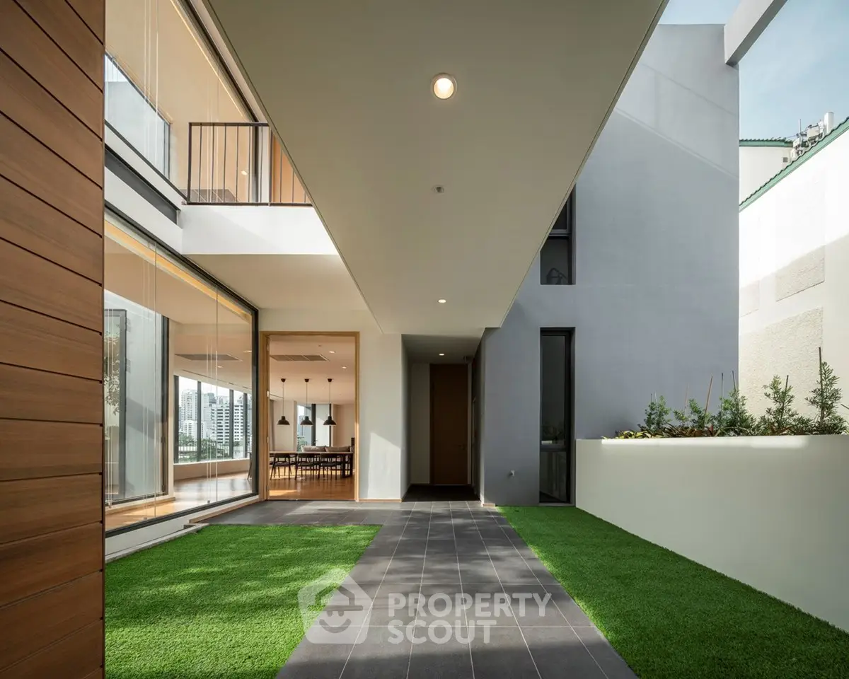 Modern architectural exterior with sleek design and lush green landscaping.