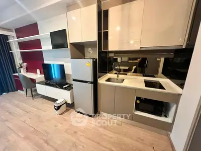 Modern kitchen with sleek cabinetry and integrated appliances in stylish apartment.