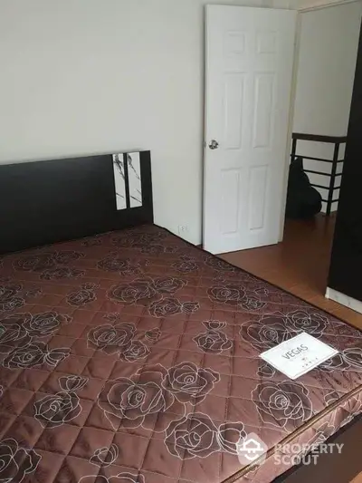 Cozy bedroom with elegant brown floral-patterned bedding and modern furnishings.