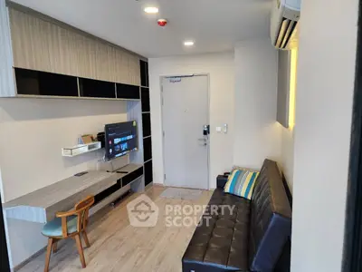 Modern living room with sleek furniture and wall-mounted TV in a cozy apartment