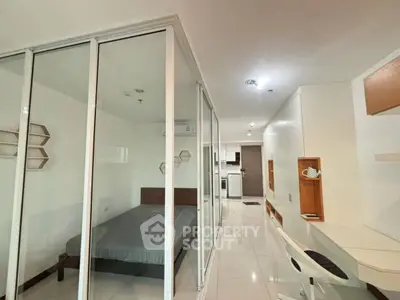 Modern studio apartment with glass partition and sleek furnishings