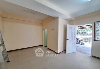 Spacious room with open door leading to outdoor area, ideal for versatile use.