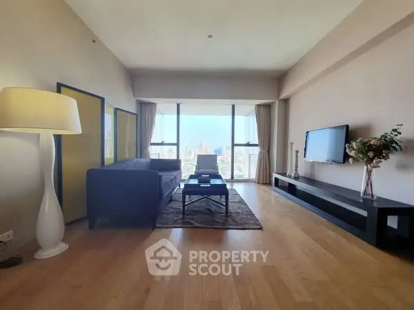 Spacious modern living room with panoramic city view and elegant decor.