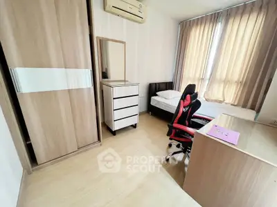 Modern bedroom with stylish furniture and natural light, featuring a workspace and cozy bed.