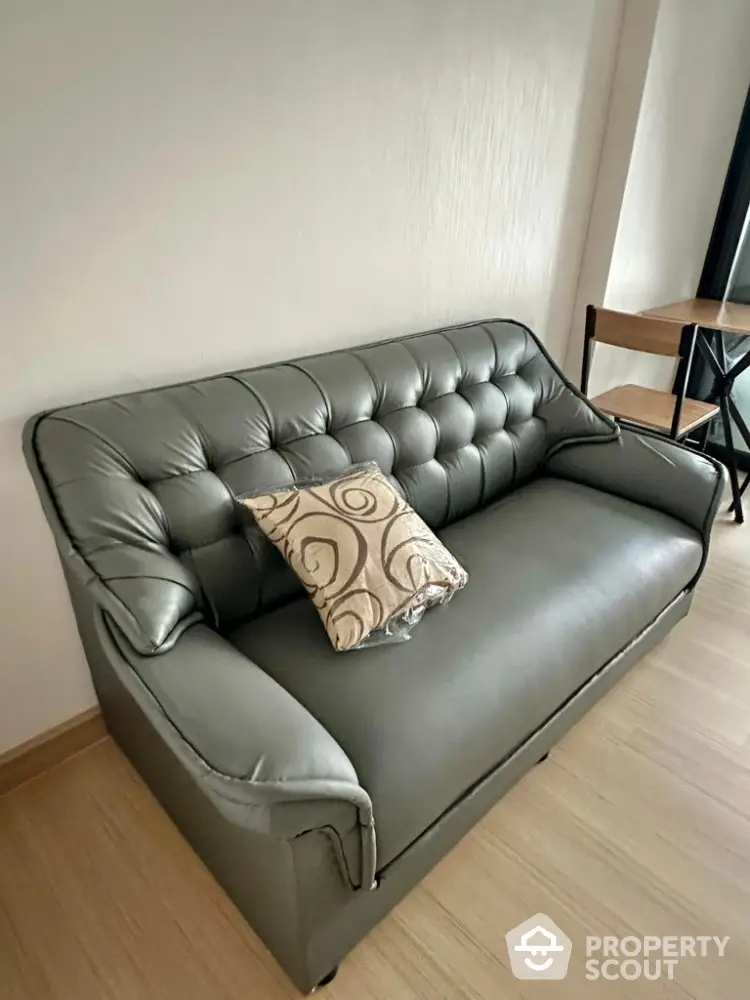 Cozy living room with stylish gray leather sofa and elegant cushion