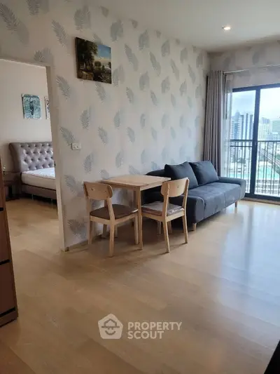 Modern living room with stylish decor and city view, featuring a cozy sofa and dining area.