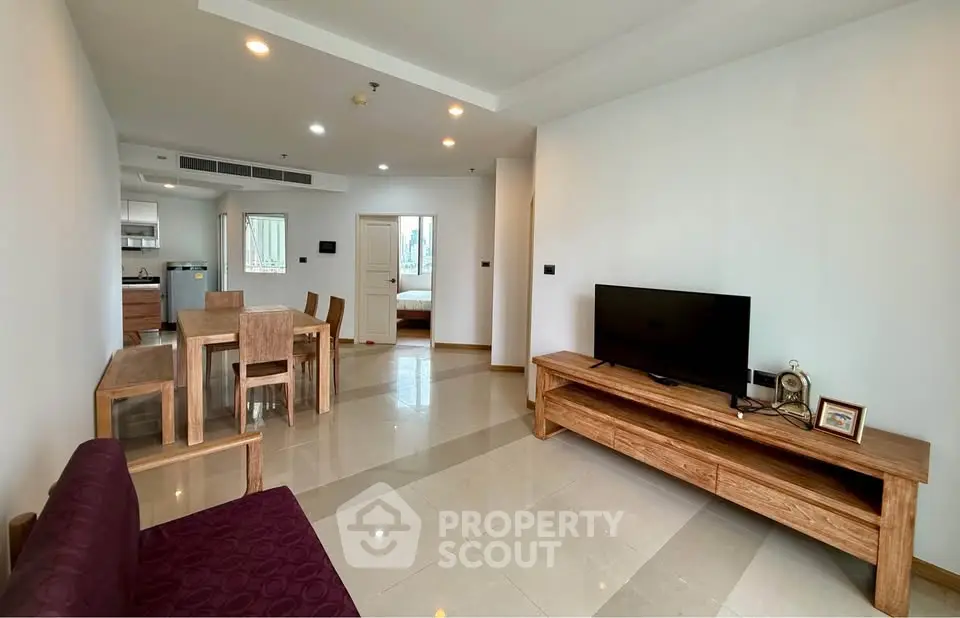 Spacious modern living room with open layout and elegant wooden furniture.