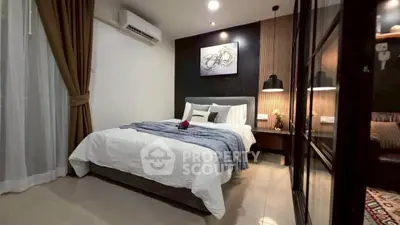 Elegant bedroom with modern decor and cozy ambiance, featuring stylish lighting and a comfortable bed.