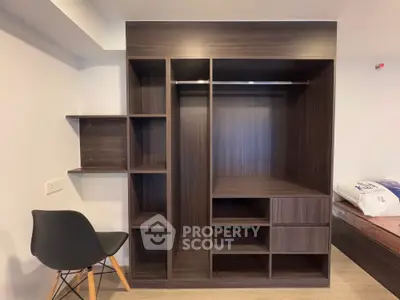 Modern wooden wardrobe with open shelves and drawers in a stylish bedroom setting