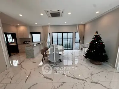 Spacious modern living room with marble flooring and Christmas tree