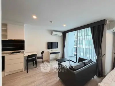 Modern living room with sleek furniture and large windows in a stylish apartment.
