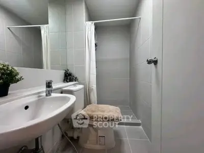Modern bathroom with sleek fixtures and walk-in shower in a contemporary home.
