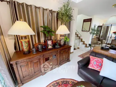 Elegant living room with stylish decor and wooden furniture, featuring a cozy seating area and decorative plants.