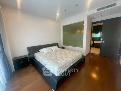 Spacious bedroom with modern design and large window for natural light