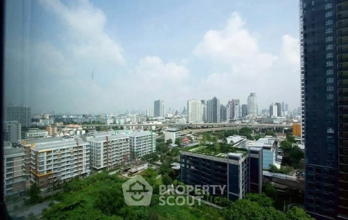 Stunning cityscape view from high-rise building showcasing urban skyline and green spaces.