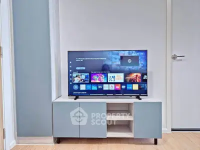 Modern living room with sleek TV setup and stylish cabinet