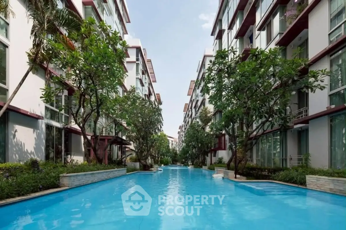 Luxurious residential complex with stunning pool and lush greenery