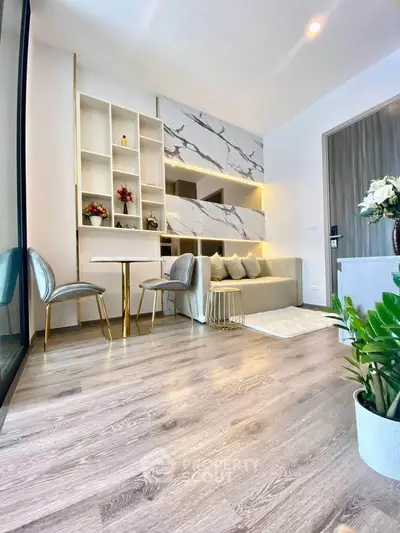 Modern living room with elegant decor, featuring marble accents and stylish furniture, perfect for urban living.