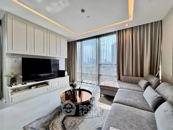 Luxurious living room with modern decor and stunning city view, featuring a large sectional sofa and sleek entertainment unit.