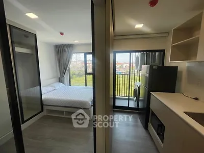 Modern studio apartment with balcony and kitchen, perfect for urban living.