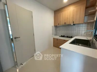 Modern kitchen with sleek cabinetry and gas stove in a compact layout