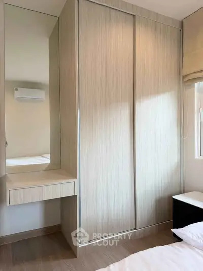 Modern bedroom with built-in wardrobe and air conditioning