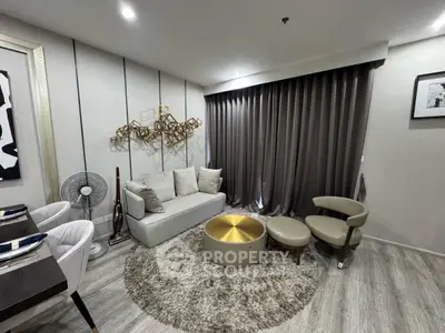 Modern living room with stylish decor and cozy seating area, featuring elegant curtains and contemporary artwork.