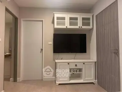 Modern living room with sleek TV setup and stylish cabinetry