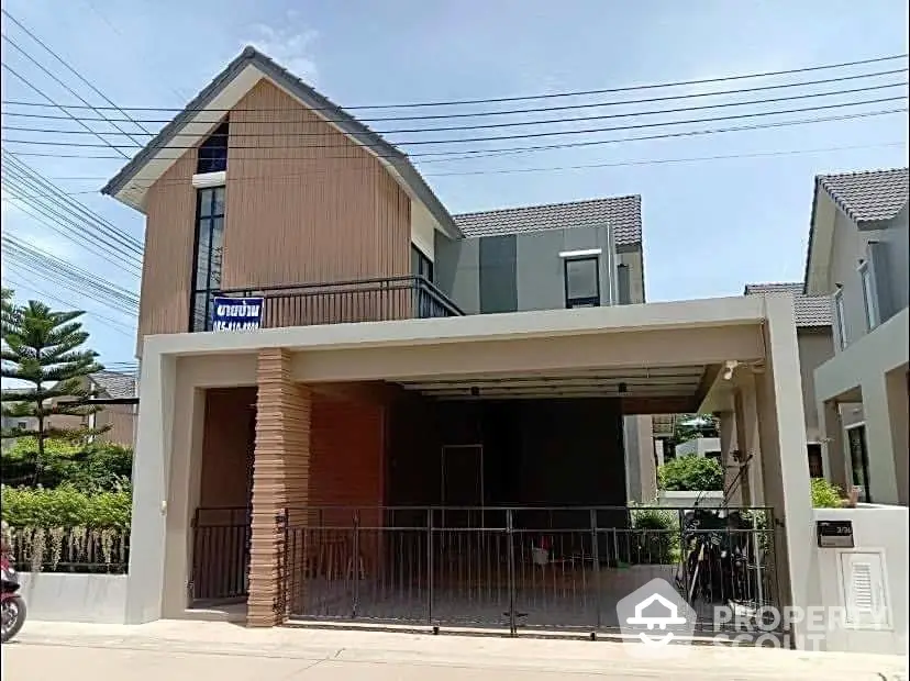 Modern two-story house with a spacious carport and contemporary design in a serene neighborhood.