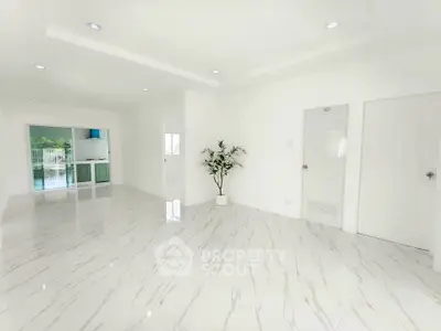 Spacious and bright living room with elegant marble flooring and modern design.