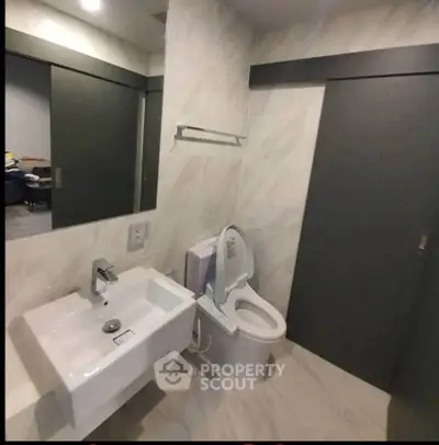 Modern bathroom with sleek design and contemporary fixtures in a stylish apartment.