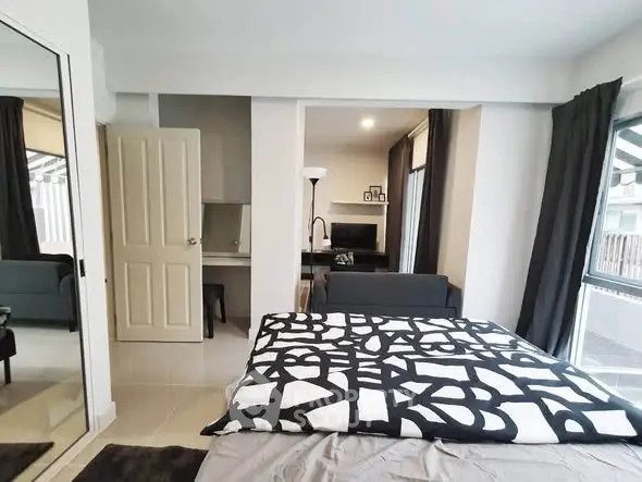 Modern bedroom with stylish decor and large windows offering ample natural light.