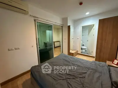 Cozy bedroom with ensuite bathroom and modern furnishings in a stylish apartment.