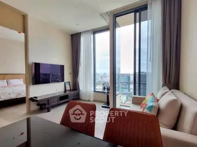 Modern living room with city view, featuring stylish furniture and large windows for natural light.