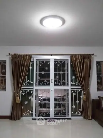 Elegant living room with sliding glass doors and luxurious curtains