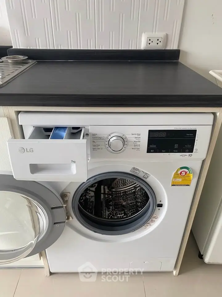 Modern washing machine in sleek laundry area with stylish countertop