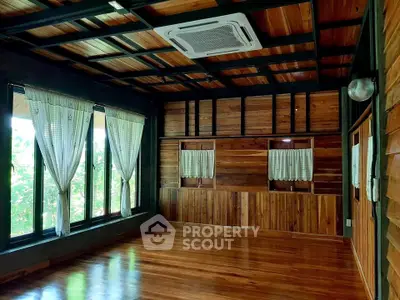 Spacious wooden interior with large windows and ceiling air conditioning