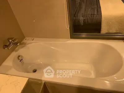 Luxurious bathroom with elegant bathtub and cozy bedroom view, perfect for relaxation and comfort.
