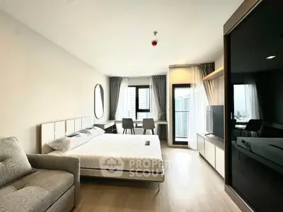 Modern bedroom with city view, featuring sleek furniture and natural light, perfect for urban living.