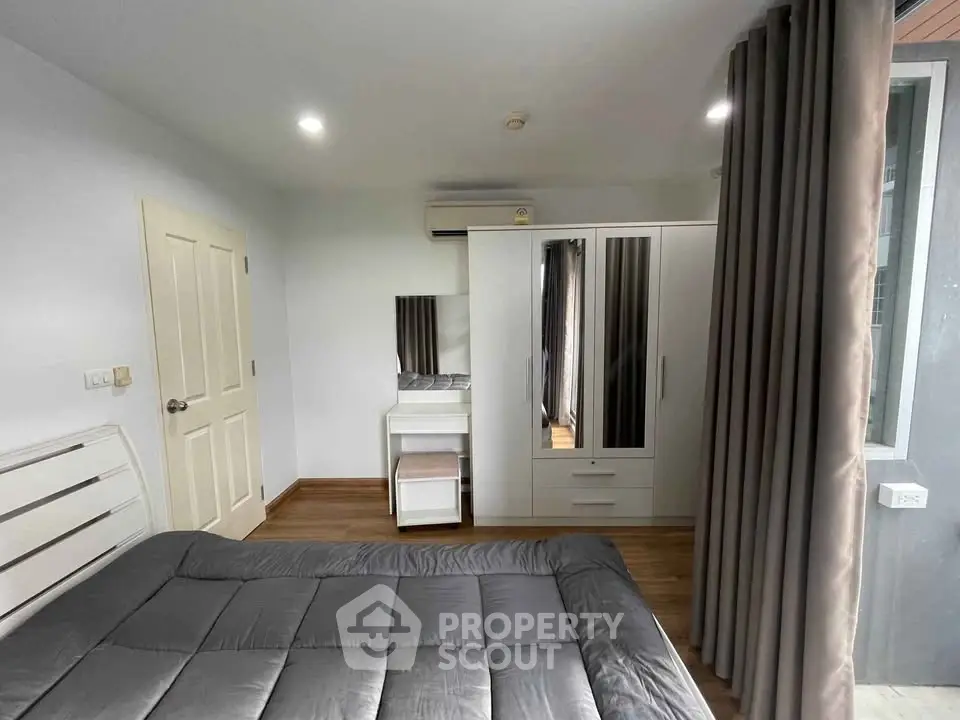 Modern bedroom with sleek furniture and natural light, featuring a cozy bed and stylish wardrobe.