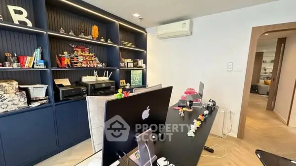 Modern home office with sleek desk, built-in shelves, and stylish decor