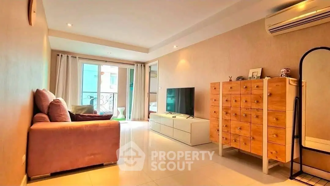 Spacious living room with modern decor and balcony access