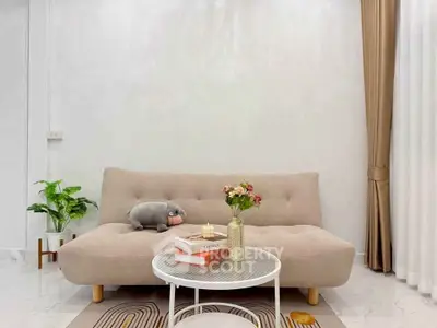 Chic modern living room with plush sofa and stylish decor, perfect for cozy relaxation.