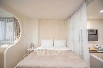 Elegant bedroom with modern decor and soft lighting, featuring a cozy bed and stylish curtains.