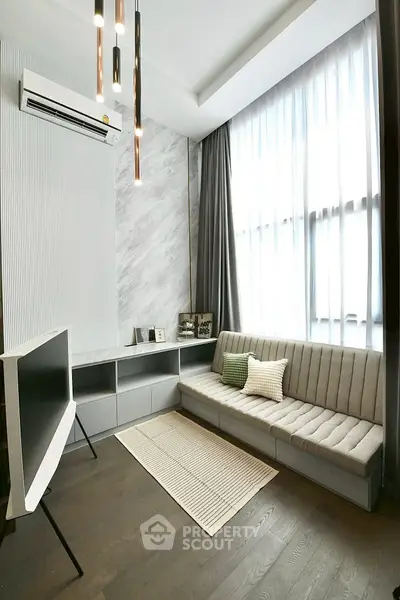 Modern living room with sleek furniture and large window
