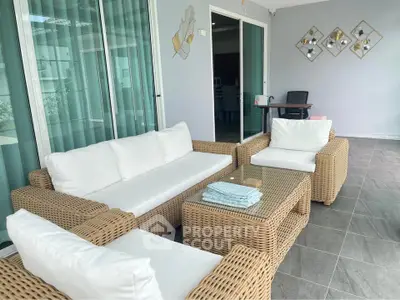 Stylish outdoor patio with wicker furniture and modern decor, perfect for relaxation and entertaining.