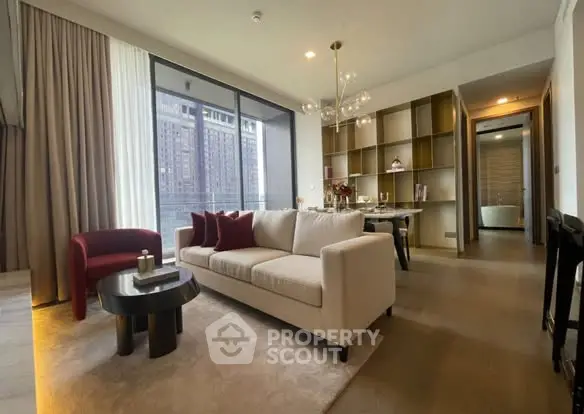 Modern living room with elegant decor and city view, featuring a cozy seating area and stylish dining space.