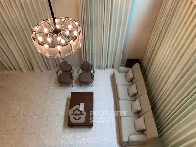 Elegant living room with high ceiling and modern chandelier